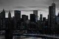 Blue lights shiningÂ in black and white night time cityscape with the Brooklyn Bridge and buildings of Manhattan in New York City Royalty Free Stock Photo